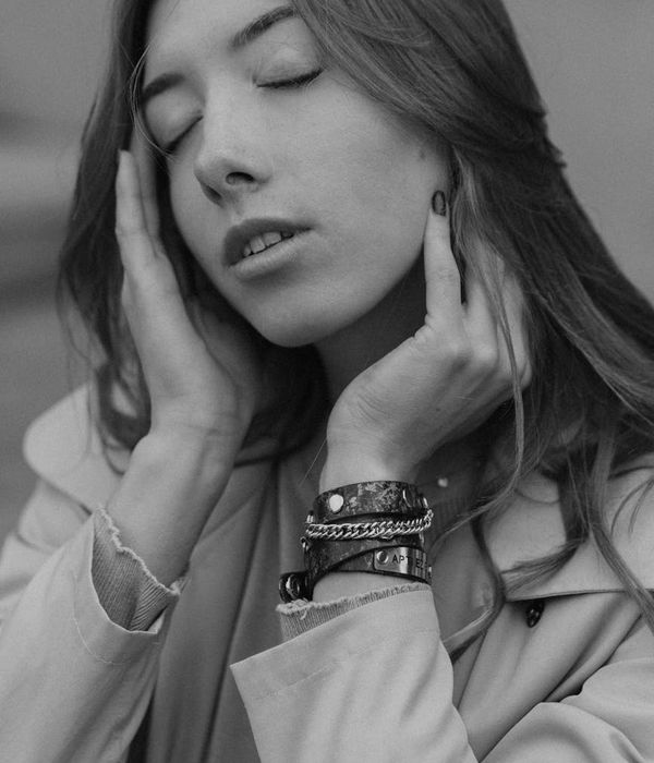 Silhouette of a person in a meditative pose against a serene background.